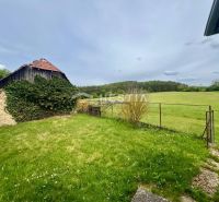 A grassy garden at a family house in Myjava with a country cottage and a beautiful view.