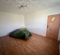 A bedroom in a 3-room apartment with a wooden decor floor and soft lighting.