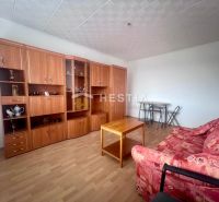 Living room in a 3-room apartment with a wooden decor floor and wooden furniture.