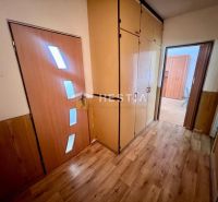 A hallway in a 3-room apartment with a wooden decor floor and storage spaces.