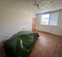 A room in a three-room apartment with a wooden decor floor and a green sheet.