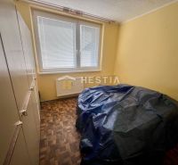 A room with yellow walls and a wooden decor floor in a 3-room apartment.