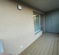 A balcony with wooden decor in a 2-room apartment.