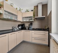 A kitchen in a 3-room apartment with light furniture and built-in appliances.