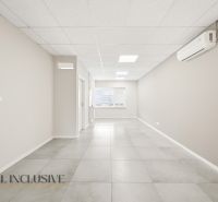 Interior space with air conditioning, bright ceiling, and tiled flooring in commercial premises.