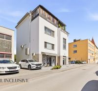 Exterior of a building with commercial spaces in Galanta, SNP district. Parking spaces in front of the building.