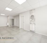 The interior of commercial spaces with white walls and tiles.
