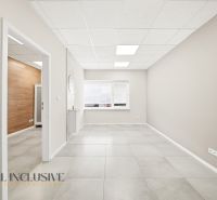 Spacious commercial spaces with light walls and tiles, featuring wooden decor.