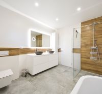 A bathroom in a family house with brown wooden decorations and two sinks.