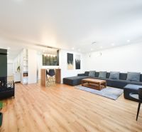 Living space in a family house with a comfortable sofa and a wooden decor floor.