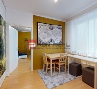 Dining nook with a map, table, and wooden decor flooring in a studio apartment.