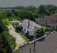A family house in Topoľnica, on Topoľnica street, surrounded by greenery and an adjacent plot.