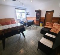 Gastro premises with seating, table football, and darts, floor with wooden decor.