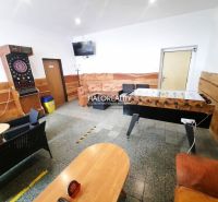 Gastro premises with wooden decor include table football and darts.