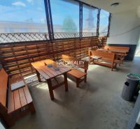 Gastro premises with wooden seating, pleasant atmosphere, and natural light.