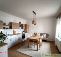 Kitchen space in a cabin with a wooden decor floor and a dining table.