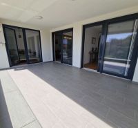 A spacious terrace with tiles in a 3-room apartment in Povljana.