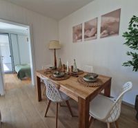 Dining room in a 3-room apartment with a table and decorative accessories.