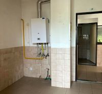 Commercial premises with a gas boiler and tiled floor.