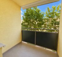 The balcony of a 3-room apartment on L. Novomeského in Pezinok with a view of greenery.