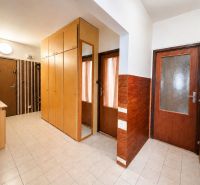 Entrance hallway with a large built-in wardrobe in a 3-room apartment, tiled floor.