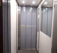 The interior of an elevator with lighting and a mirror in a building.