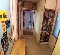 A hallway in a 3-room apartment with decorations, wardrobes, and a floor with a wooden decor.