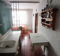 A kitchen with older furniture and decor in a 3-room apartment.