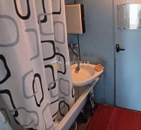 A bathroom with a shower curtain and a mirror in a 3-room apartment.