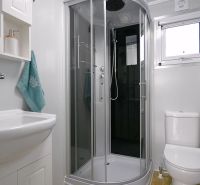 A bathroom with a modern shower and sink in a family house.