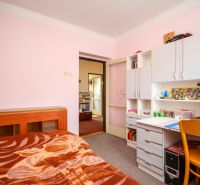 A children's room in a family house with white furniture and a writing desk.