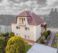 A family house on Niva Street in Trenčín with a landscaped garden and a sloped roof.