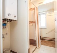 A bathroom in a family house with a gas boiler and a shower enclosure.