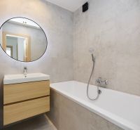 A bathroom with a bathtub and a sink in a 4-room apartment with wooden decor.