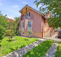 A family house in Gabčíkovo with a landscaped garden, parking, and trees.