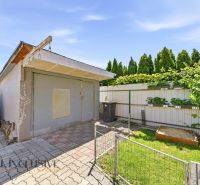 A family house in Gabčíkovo with a garage, terrace, and planter boxes in the garden.
