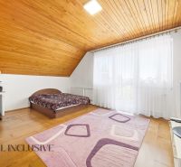 Bedroom in a family house with wooden floor decor, bed, and work desk.
