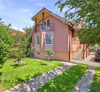 A family house in Gabčíkovo with a landscaped garden, garage, and sunny facades.