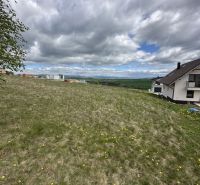 View of a residential plot in Malý Slavkov with a panoramic view of the landscape.