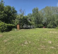 A plot for residential use in Potônske Lúky, surrounded by trees and lawn, ideal for construction.