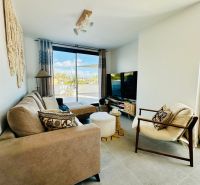Living room in a 3-room apartment with stylish furnishings and a large window.
