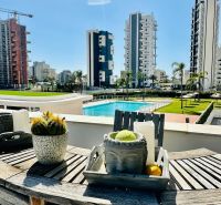 A balcony of a 3-bedroom apartment in Calpe with a view of the pool and high-rise buildings.
