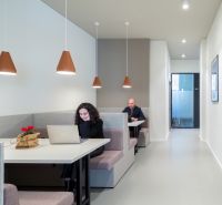 Offices with sofas and laptops, minimalist lighting and wall decorations.