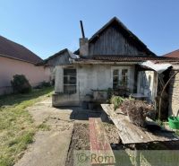 Older family house in Šurany with wooden decor and a garden.