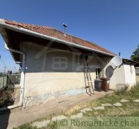A family house in Šurany with a red roof and a satellite dish.