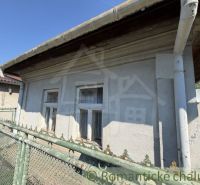 A family house in Šurany with older windows and a metal fence.