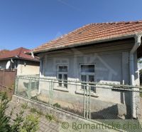 A family house in Šurany with a traditional gable roof and a simple fence.