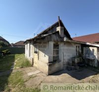 An older family house in Šurany with a stone facade and an extension.