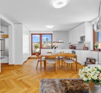 A kitchen with built-in cabinets and dining area, wooden decor flooring, 4-room apartment.
