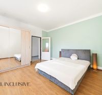 Bedroom in a family house with a wooden decor floor and a built-in wardrobe.